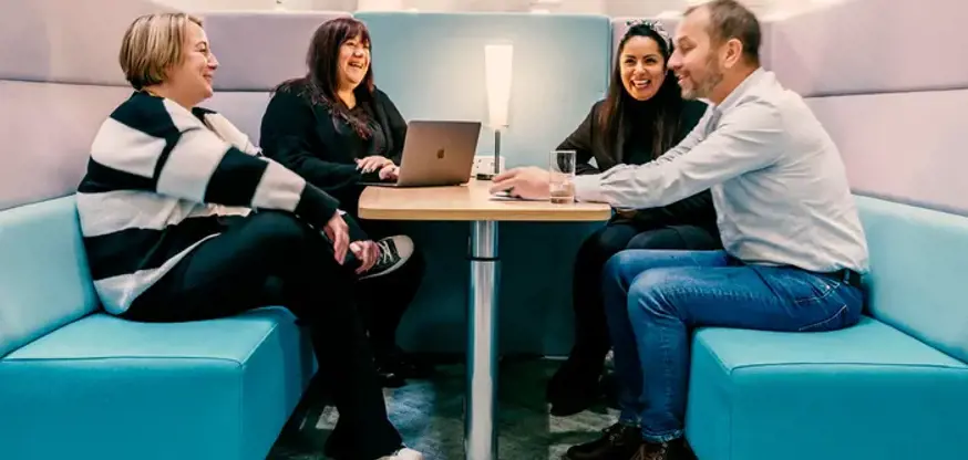 Four people having a meeting in a booth