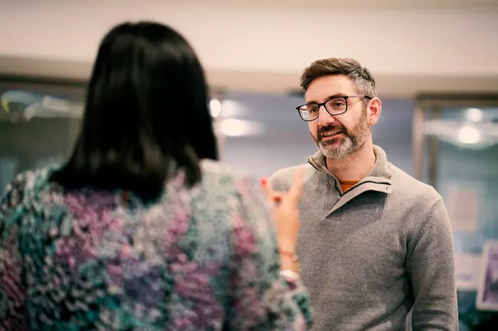 Two colleagues standing talking