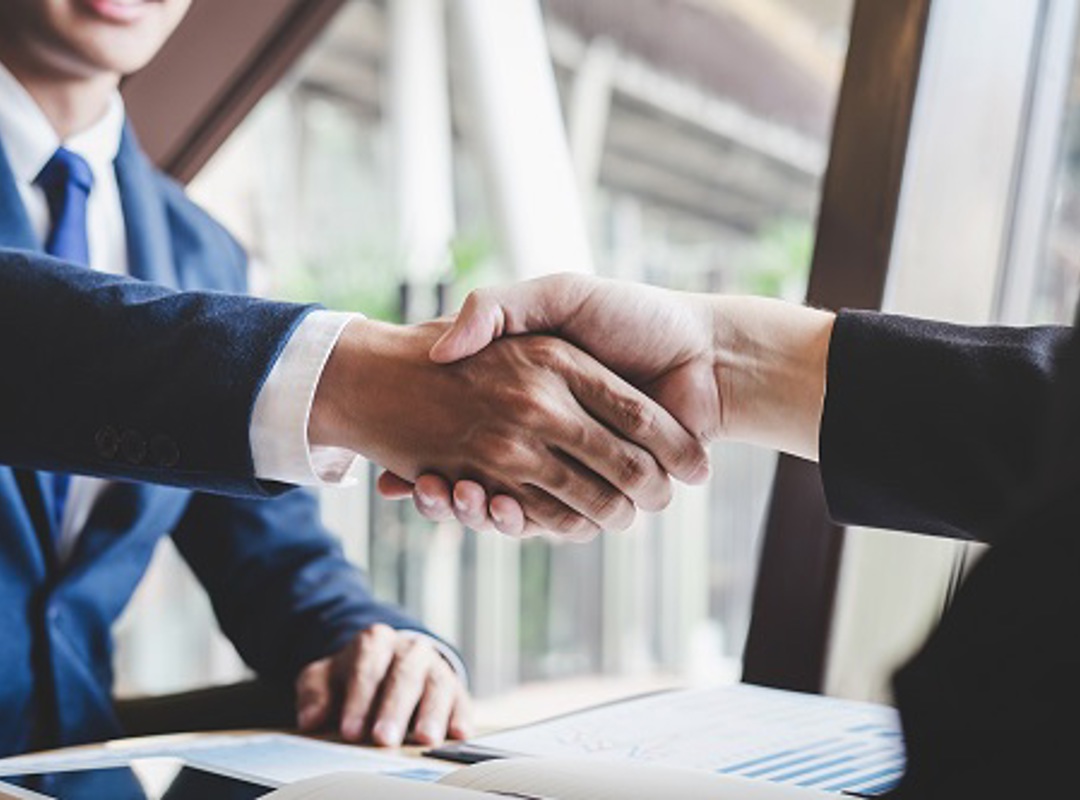 Two People Shaking Hands Smaller