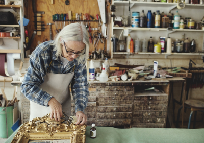 Person Restoring Mirror In Workshop