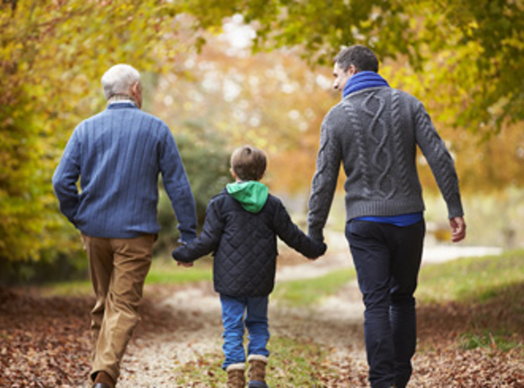 Three Generation Of People Walking In Forest