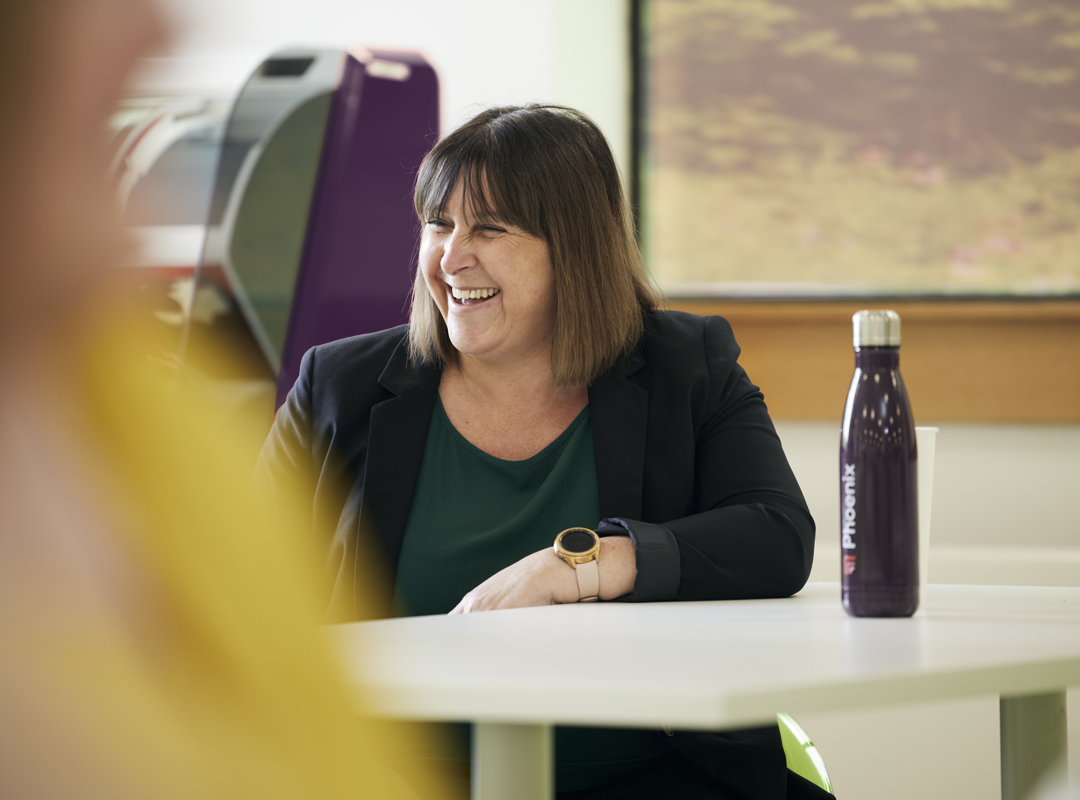 Woman In The Office With A Phoenix Group Water Bottle