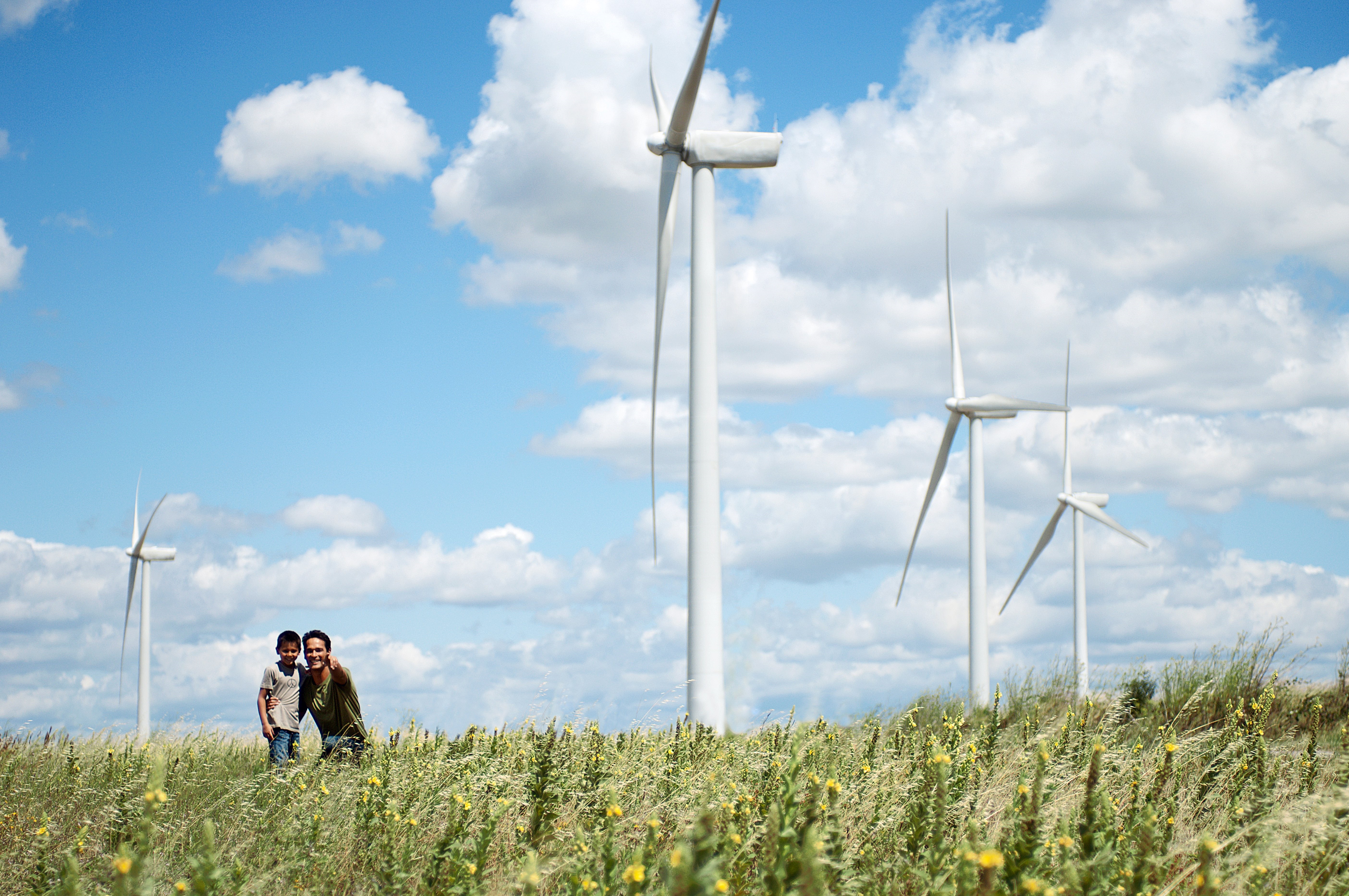 Climate Report Front Cover Family In Front Of Windfarm