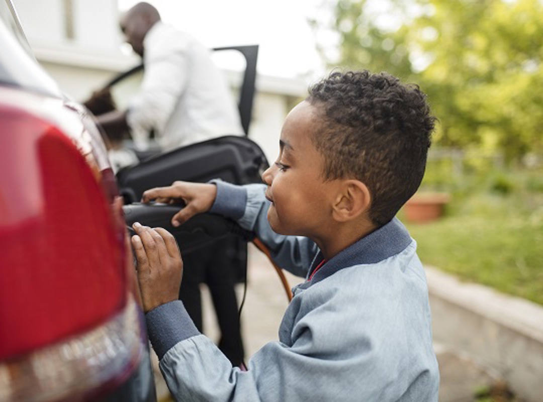 Child Next To An Electric Car
