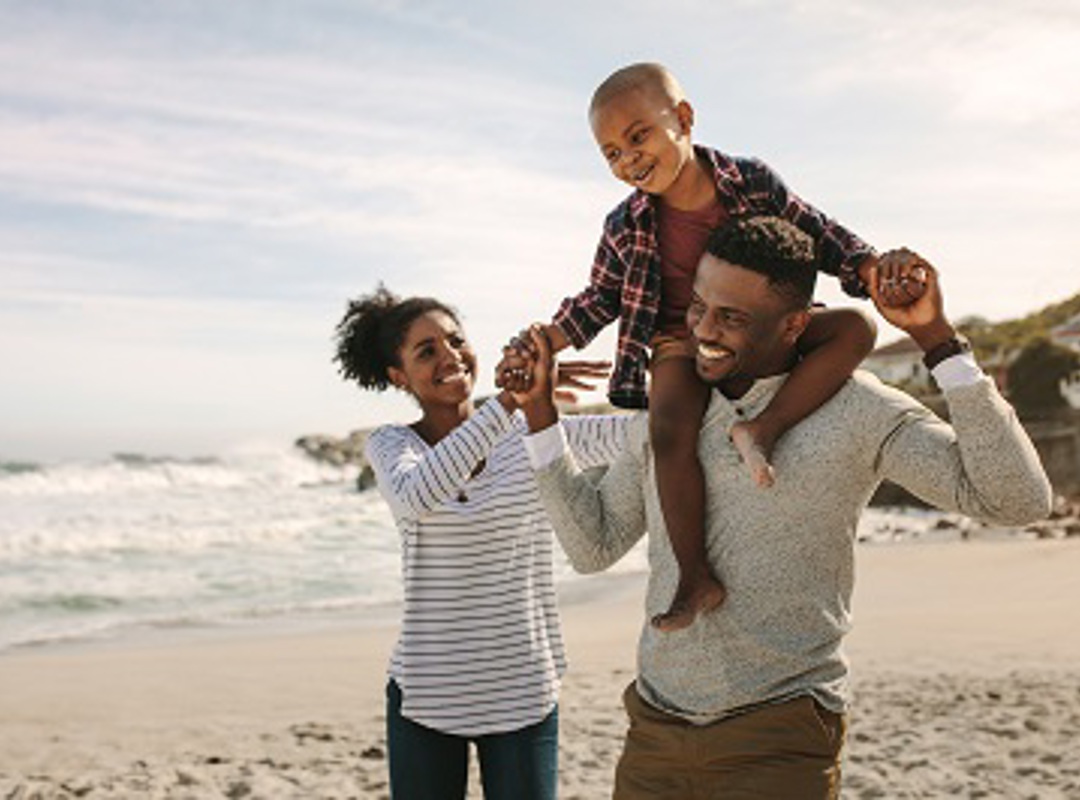 Family With Small Child By The Sea 400X