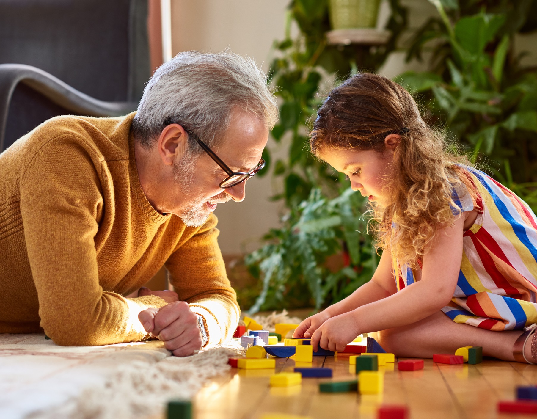 Grandfather And Grandchild Playing With Lego