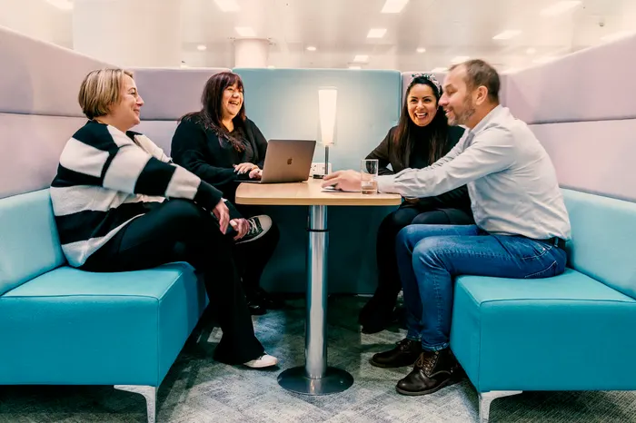 Four people having a meeting in a booth