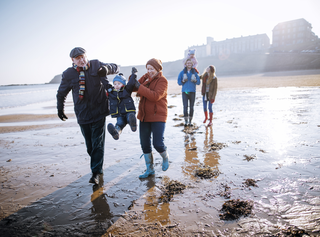 Family Walking On The Beach